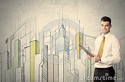 Businessman standing with drawn cityscape Stock Photo