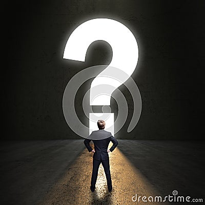 Businessman standing in front of a questionmark portal Stock Photo