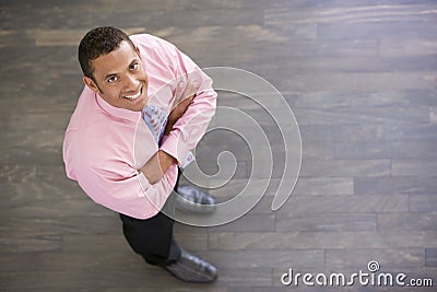 Businessman standing indoors smiling Stock Photo