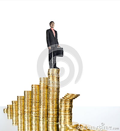 Businessman standing on rouleau gold monetary Stock Photo