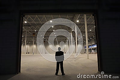 Businessman Standing At Warehouse Entrance Stock Photo