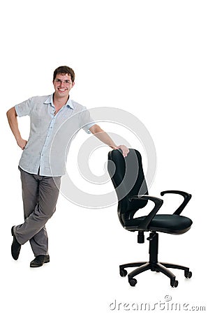 The businessman stands at an armchair Stock Photo