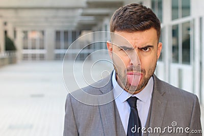 Businessman sticking his tongue out Stock Photo