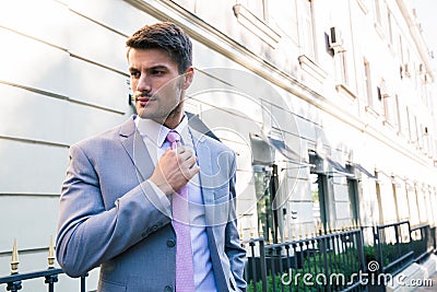 Businessman straightens his tie Stock Photo