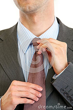 Businessman straightens tie. Closeup Stock Photo