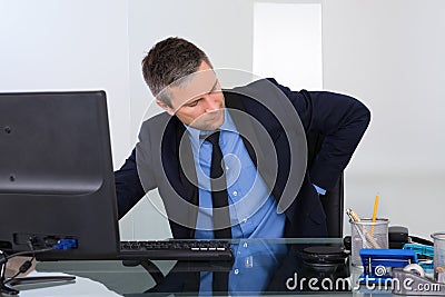 Businessman suffering from backpain Stock Photo
