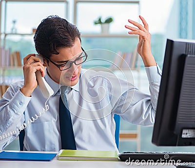 Businessman suffering from excessive armpit sweating Stock Photo