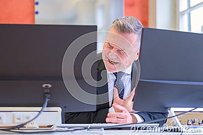 Businessman suffering a heart attack or infarct Stock Photo