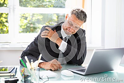 Businessman Suffering From Shoulder Pain Stock Photo