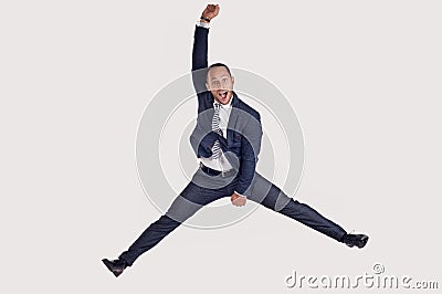 A businessman in a suit jumps for joy. Stock Photo