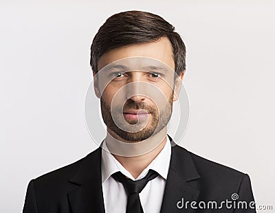 Businessman In Suit Looking At Camera Over White Background, Stock Photo