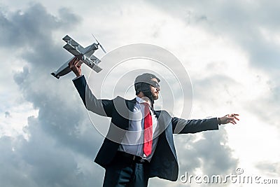 businessman in suit and pilot hat launch plane toy. boost idea Stock Photo