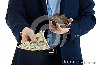 Businessman in suit takes out dollar from wallet, hand holding cash, closeup. Stock Photo