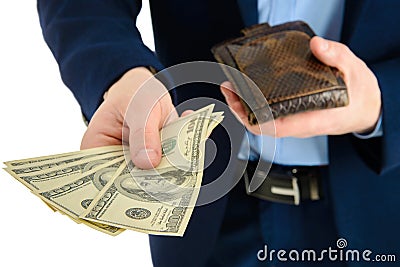 Businessman in suit takes out dollar from wallet, hand holding cash, closeup. Stock Photo