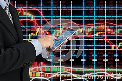 Businessman in Suit use Digital Wireless Tablet analyze investment in StockMarket Stock Photo