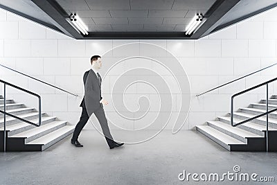 Businessman in suit walking in metro station Stock Photo