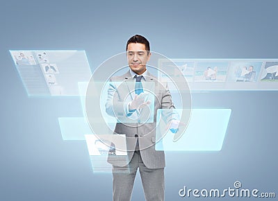 Businessman in suit working with virtual screens Stock Photo