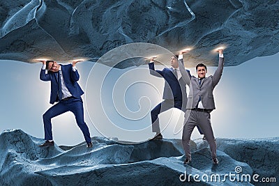 The businessman supporting stone under pressure Stock Photo