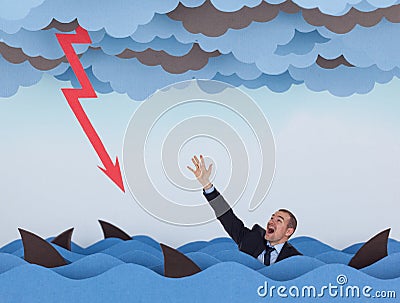 Businessman surrounded by sharks in stormy sea Stock Photo