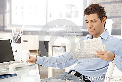 Businessman taking break in office Stock Photo