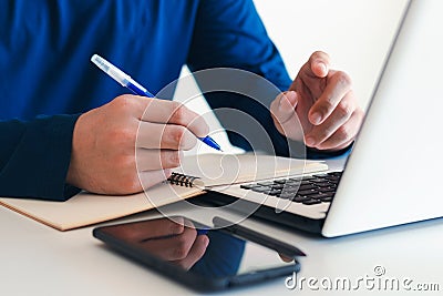 Businessman taking notes Summarize the meeting online with laptop. Stock Photo