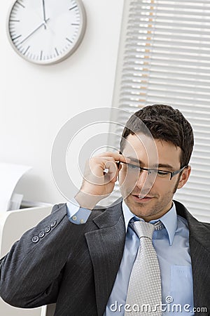 Businessman taking off glasses Stock Photo