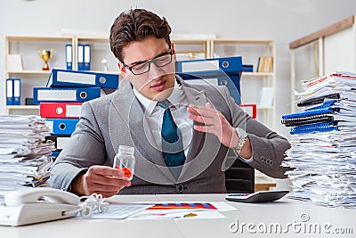 The businessman taking pills to cope with stress Stock Photo
