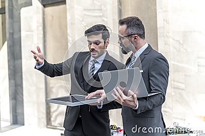 Businessman talking and checking quality power solar cell with laptop computor on site new project power solution business Stock Photo