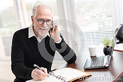 Businessman talking on mobile phone to make an appointment Stock Photo