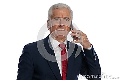 Businessman talking on the phone and feeling insulted Stock Photo