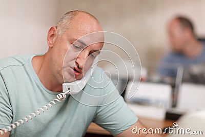 Businessman talking on phone in office Stock Photo