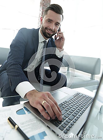 Foreground businessman talking on a smartphone Stock Photo