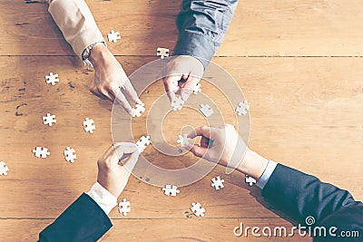 Businessman team work holding two jigsaw Stock Photo