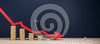 Businessman with telescope standing on abstract falling golden coins chart with blue downward arrow in dark interior. Financial Stock Photo