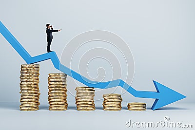 Businessman with telescope standing on abstract falling golden coins chart with blue downward arrow in light interior. Financial Stock Photo