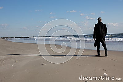 Businessman thinking on the beach Stock Photo