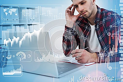 Businessman thinking with laptop and notebook, graph changes and bar chart Stock Photo