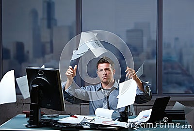 Businessman throwing documents into air Stock Photo