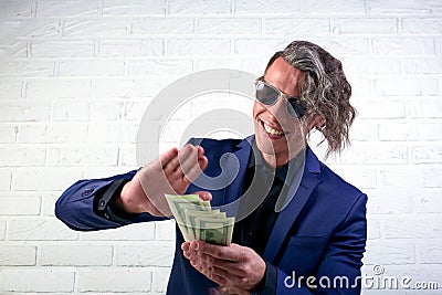 Businessman throwing money on white background. Man in suit wear wasting money, throwing banknotes, dollars. Stock Photo