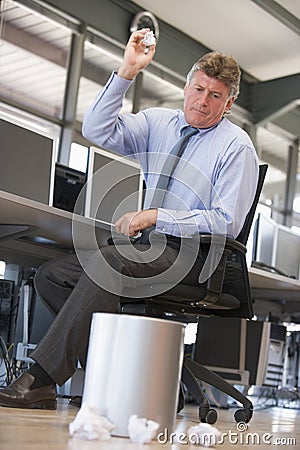 Businessman throwing paper into bin Stock Photo