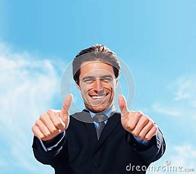 Businessman, thumbs up and portrait for success, support or like emoji on blue sky background for real estate. Face of Stock Photo