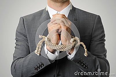 Businessman with tied hands Stock Photo