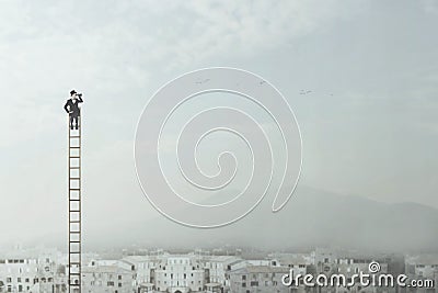 Businessman at the top of a long ladder observes the city with his binoculars Stock Photo