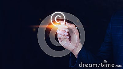 Businessman touching Copyright icon, patents and intellectual property protection law and rights. with symbol of the copyright. Stock Photo