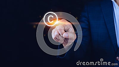 Businessman touching Copyright icon, patents and intellectual property protection law and rights. with symbol of the copyright. Stock Photo