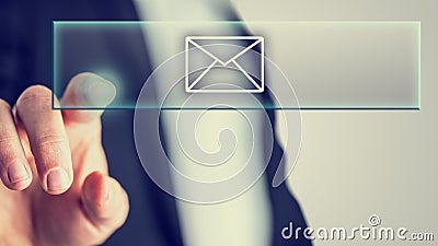 Businessman touching a mail icon Stock Photo