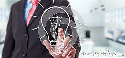 Businessman touching a sketch lightbulb Stock Photo