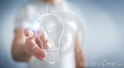 Businessman touching a sketch lightbulb Stock Photo