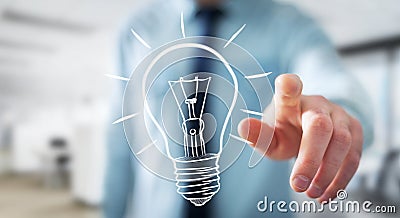 Businessman touching a sketch lightbulb Stock Photo