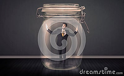 Businessman trapped into a glass jar concept Stock Photo